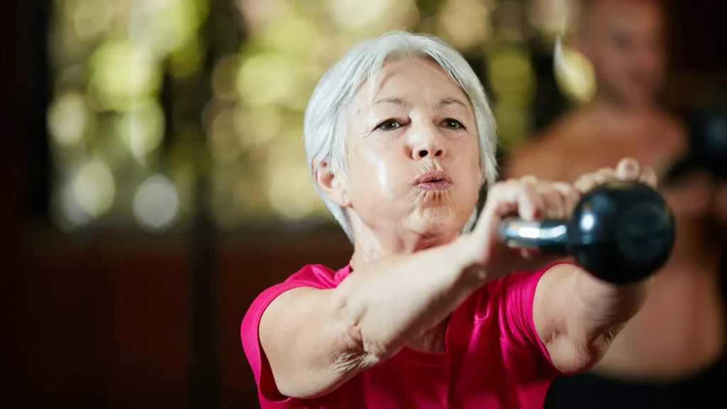 Toning Arms Without the Bulk: Is It Achievable? 1 Woman doing resistance band exercises for toned arms Newmarket